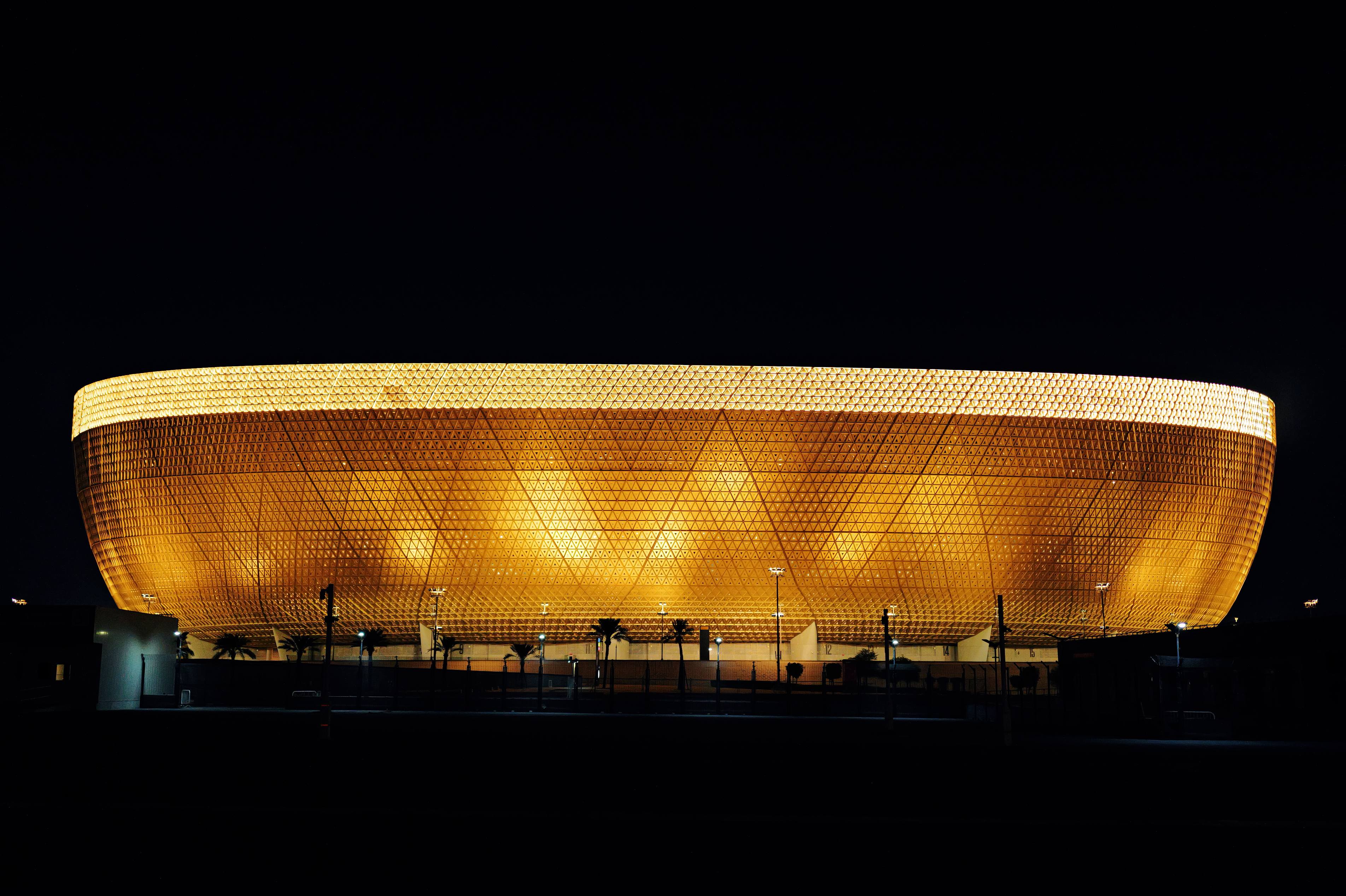 Architectural wall washing lighting illuminating a large textured building facade with warm LED illumination