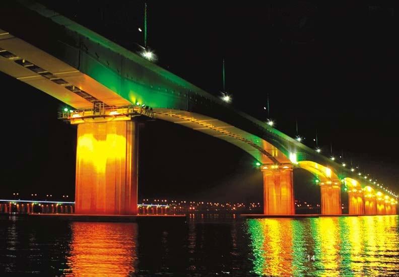 RGB LED flood lighting illuminating bridge understructure with uniform beam distribution and water reflection