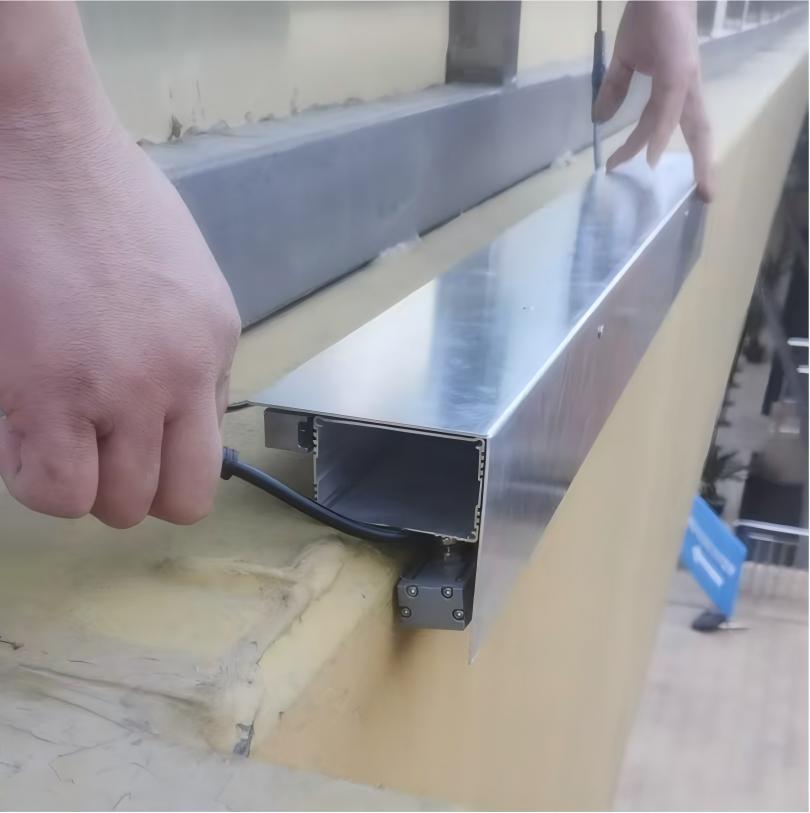 Custom aluminum extrusion housing designed for integrated wall washer and linear facade lighting installation