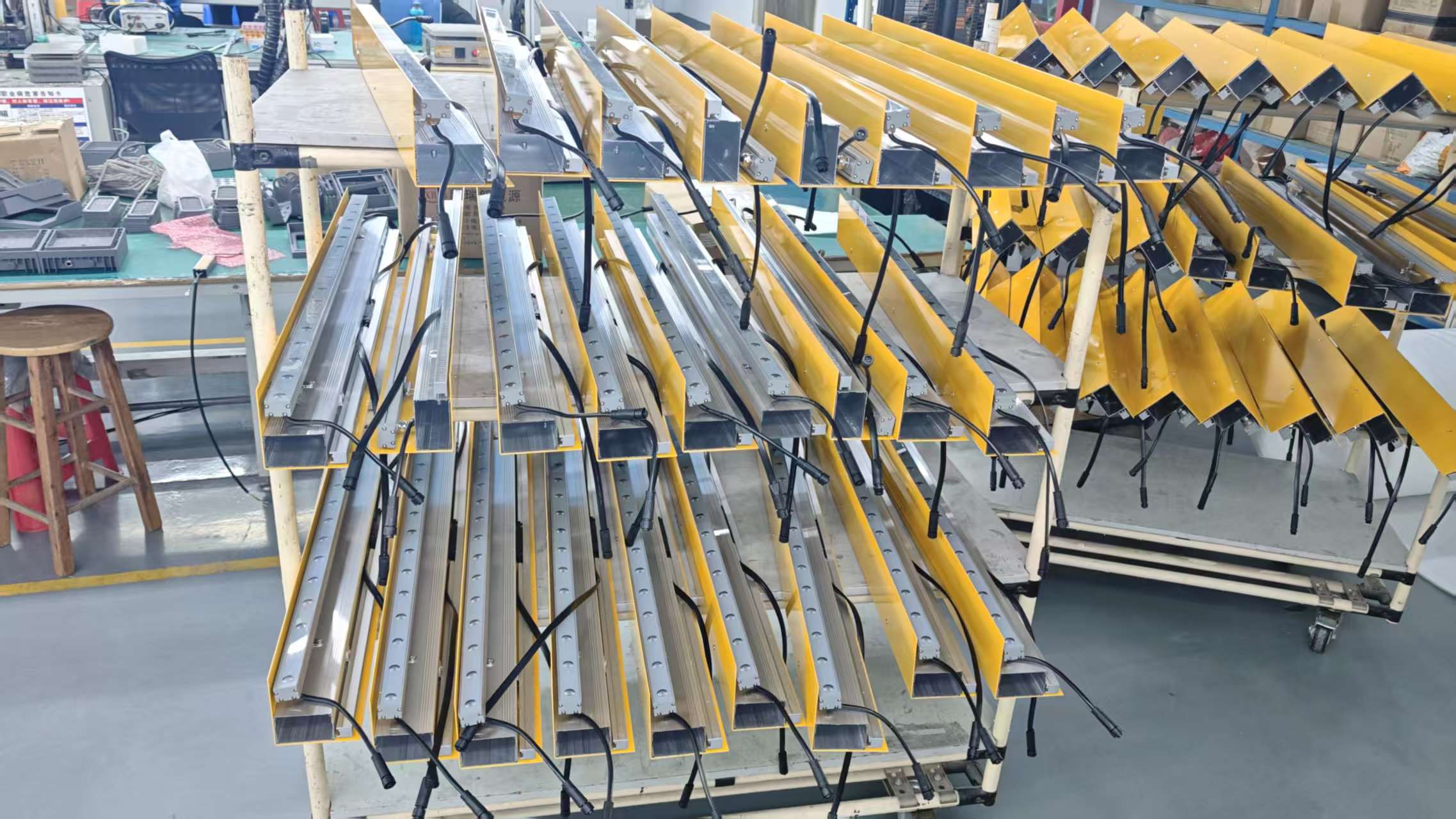 Factory assembly of custom architectural linear light fixtures with aluminum housings and wiring