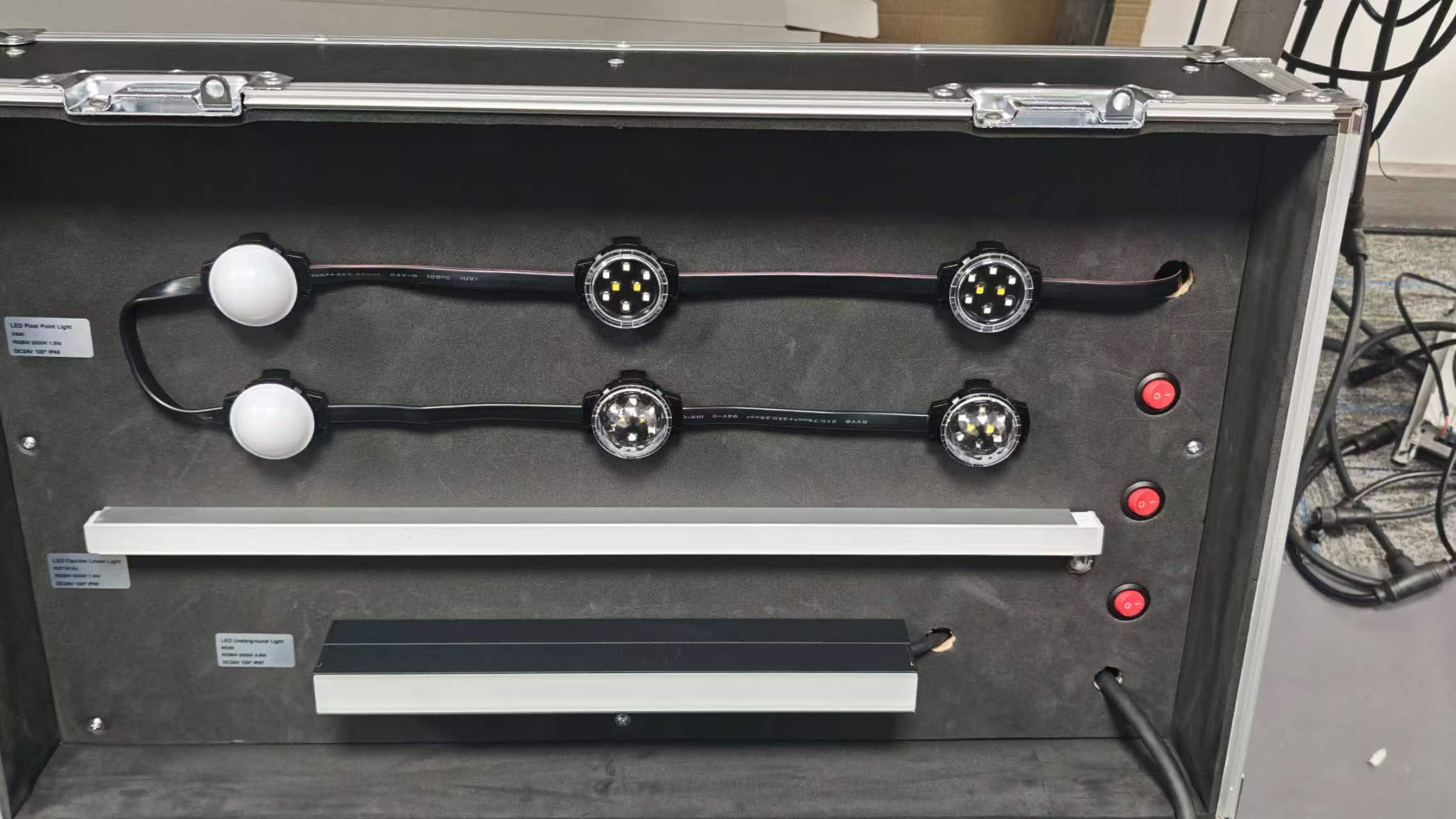 Portable LED lighting demo case showing DMX512 controller, linear LED lights, wall washers, and pixel lights for architectural lighting demonstration