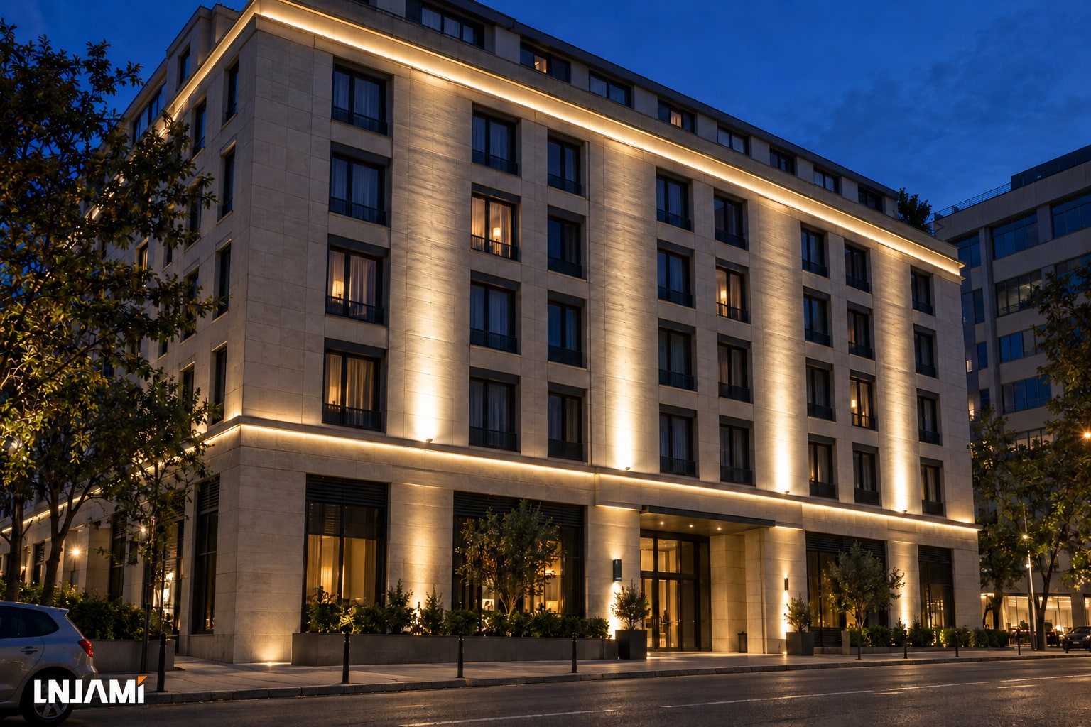 AI-generated illustration of a stone-clad commercial building with warm-white linear accents and facade wall washing at night
